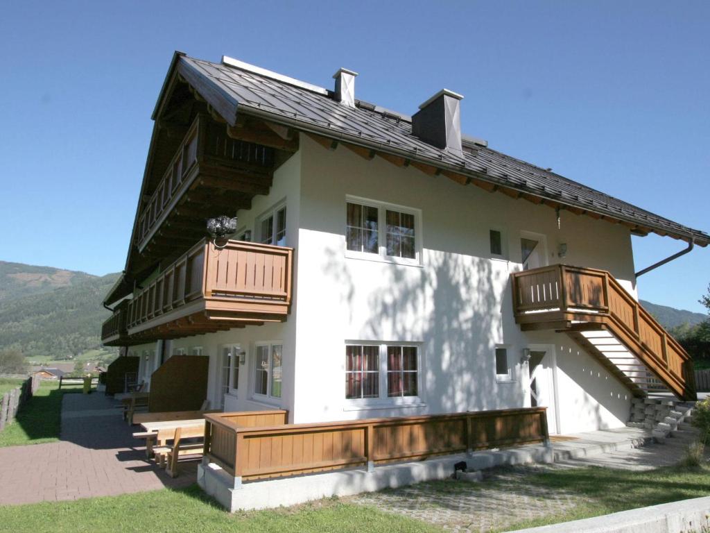 a house with wooden balconies on the side of it at Apartment in St Margarethen in the ski area in Sankt Margarethen im Lungau