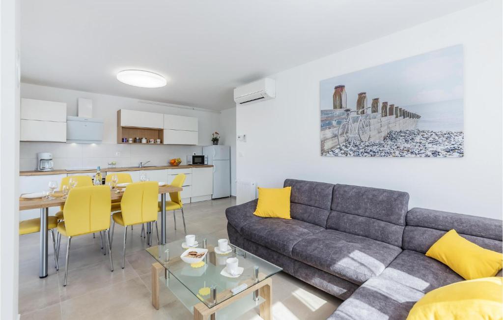 - un salon avec un canapé gris et des fauteuils jaunes dans l'établissement Beautiful Apartment In Pula With Wifi, à Pula