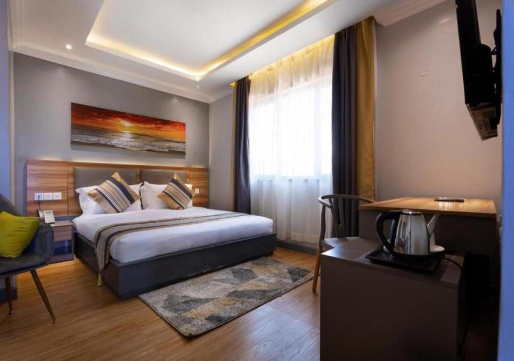 Postel nebo postele na pokoji v ubytování Raha Suites - Westlands