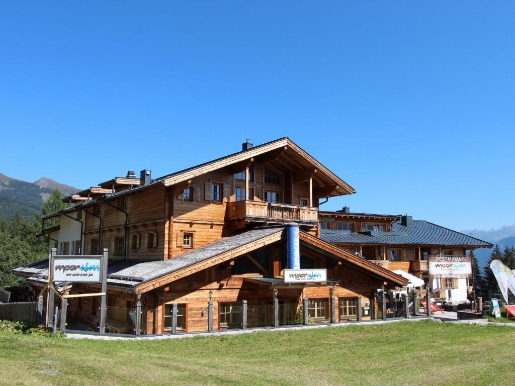 a large wooden building in the mountains at Apartment with a lift in Mittersill Salzburg in Hollersbach im Pinzgau
