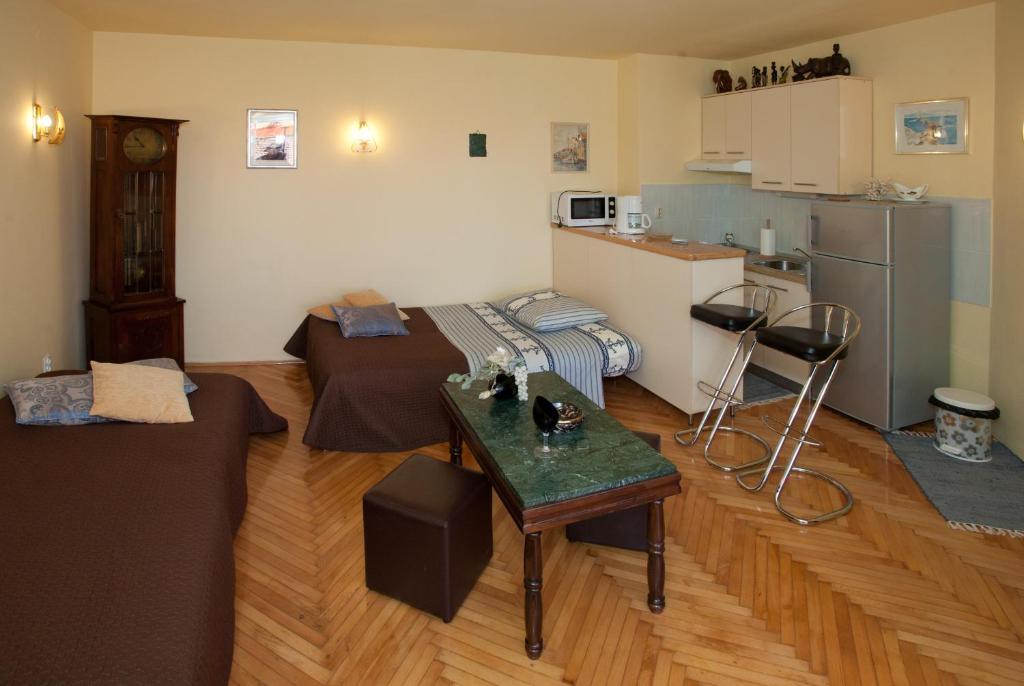 a living room with a couch and a table at Apartments Beautiful Sandy Beach in Split