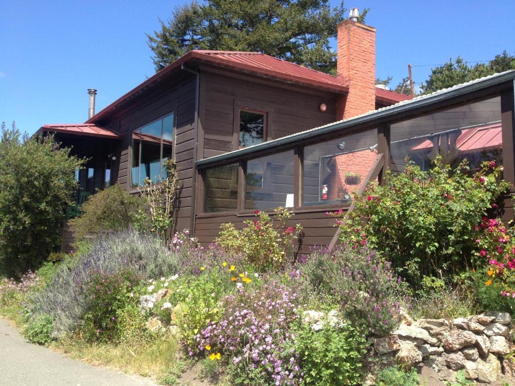 a house with a garden in front of it at HI Point Reyes Hostel in Point Reyes Station