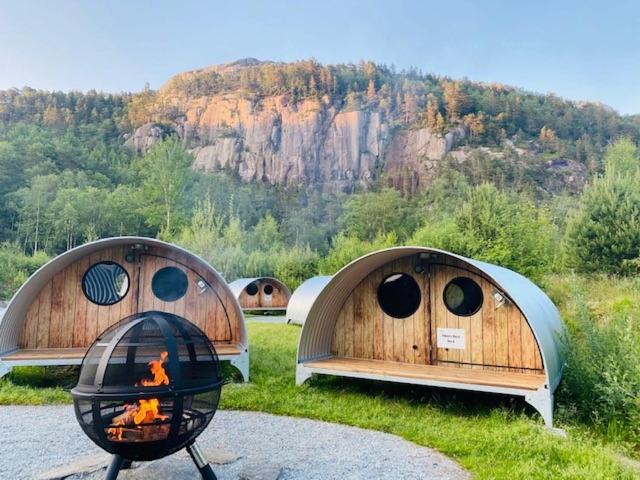 two domes with a fire in a grill in a field at Hikers Camp, Part of Preikestolen BaseCamp in Jørpeland