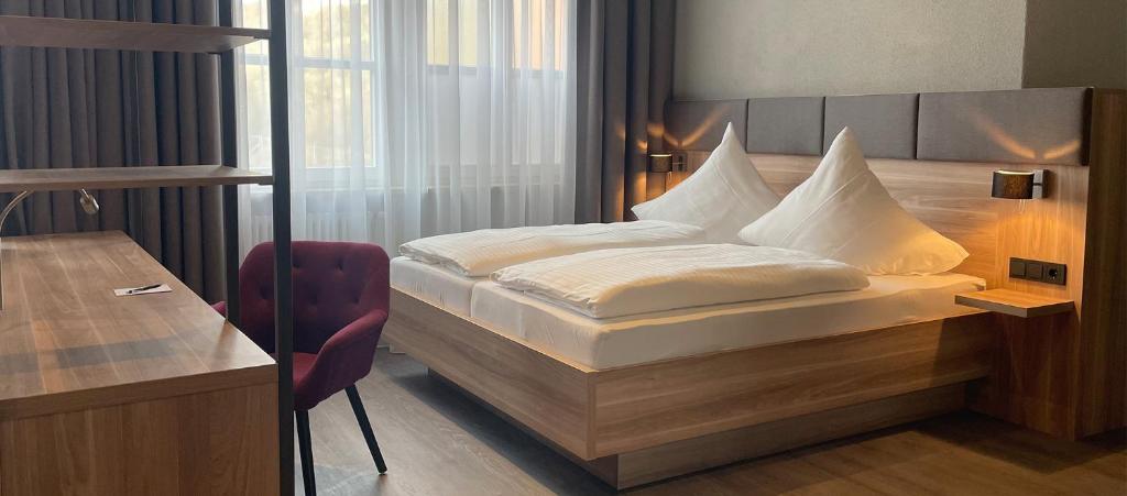 Postel nebo postele na pokoji v ubytování Hotel Das Bischof