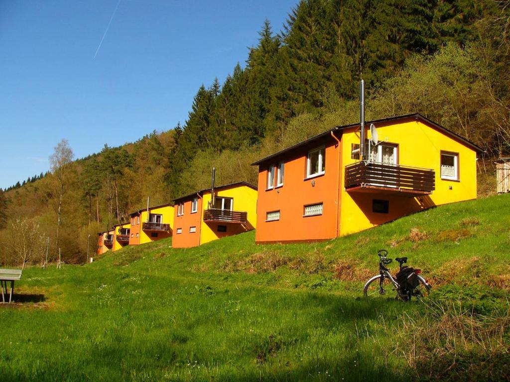 a row of houses on a hill with a bike at Waldblick in Herl