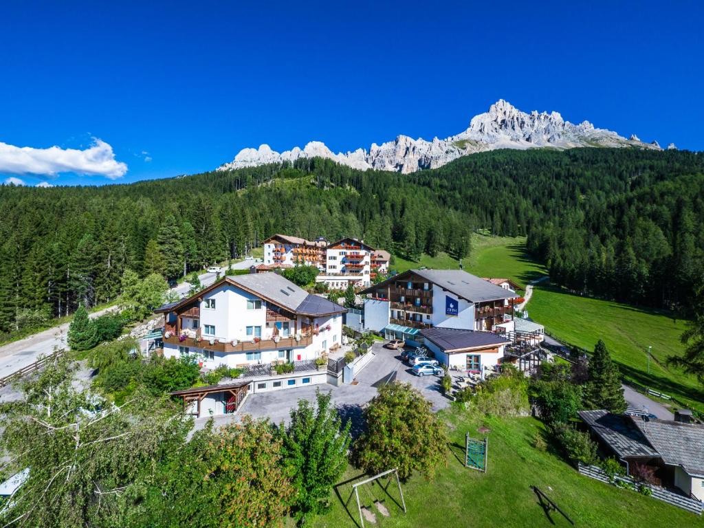 an aerial view of a resort in the mountains at Good Life Hotel Zirm in Obereggen