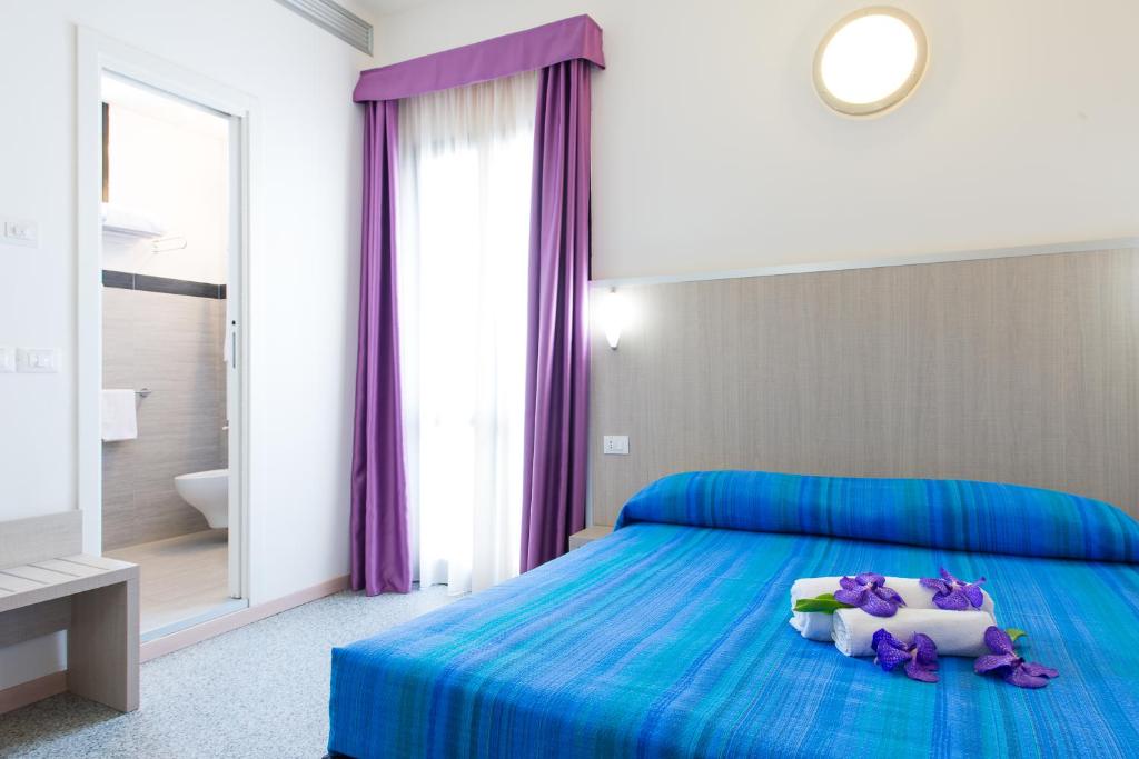Postel nebo postele na pokoji v ubytování Hotel Villa Argia Rimini Marina Centro