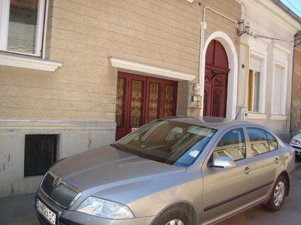 a silver car parked in front of a house at Guesthouse Daniel in Oradea