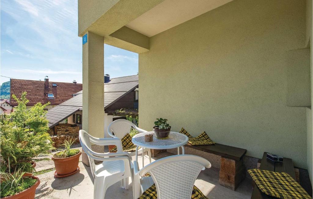 a patio with chairs and a table on a balcony at Stunning Apartment In Delnice With Wifi in Delnice