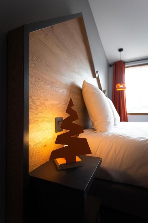 Postel nebo postele na pokoji v ubytování Hotel Base Camp Lodge - Les 2 Alpes