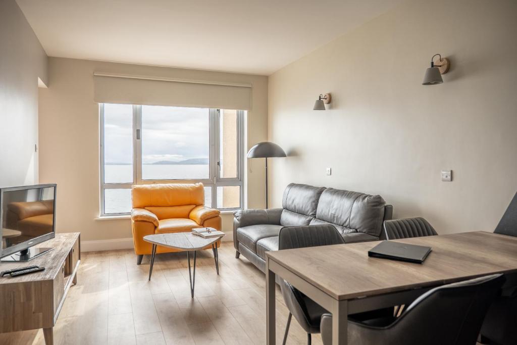 a living room filled with furniture and a couch at Galway Bay Sea View Apartments in Galway