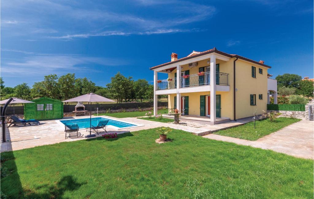 a house with a pool in the yard at Stunning Home In Nedescina With Outdoor Swimming Pool in Nedeščina