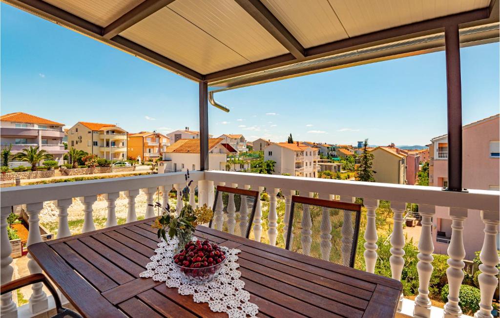 a wooden table on a balcony with a view at Lovely Apartment In Vodice With Wifi in Vodice