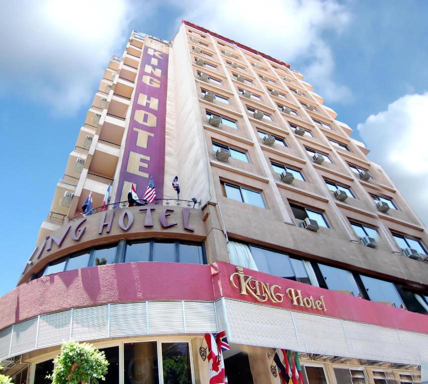 a tall building with a kings hotel sign on it at King Hotel Cairo in Cairo