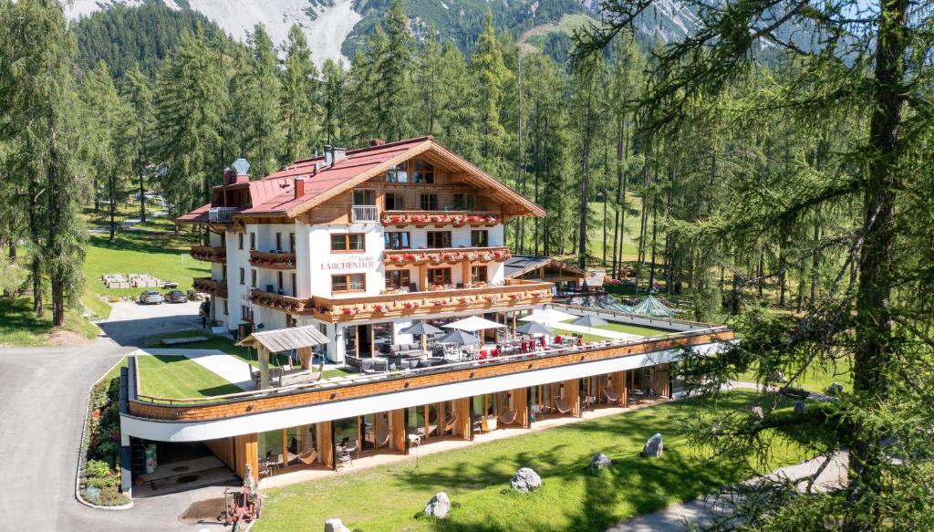 an aerial view of a building in a forest at Hotel Lärchenhof in Ramsau am Dachstein