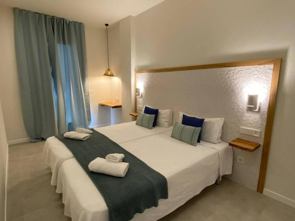 a hotel room with two beds with towels on them at Apartamento Sa Mesquida 7 in Cala Llonga