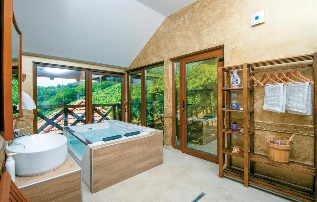 a bathroom with a large tub and a large window at Amazing Home In Vinica With Wifi in Vinica
