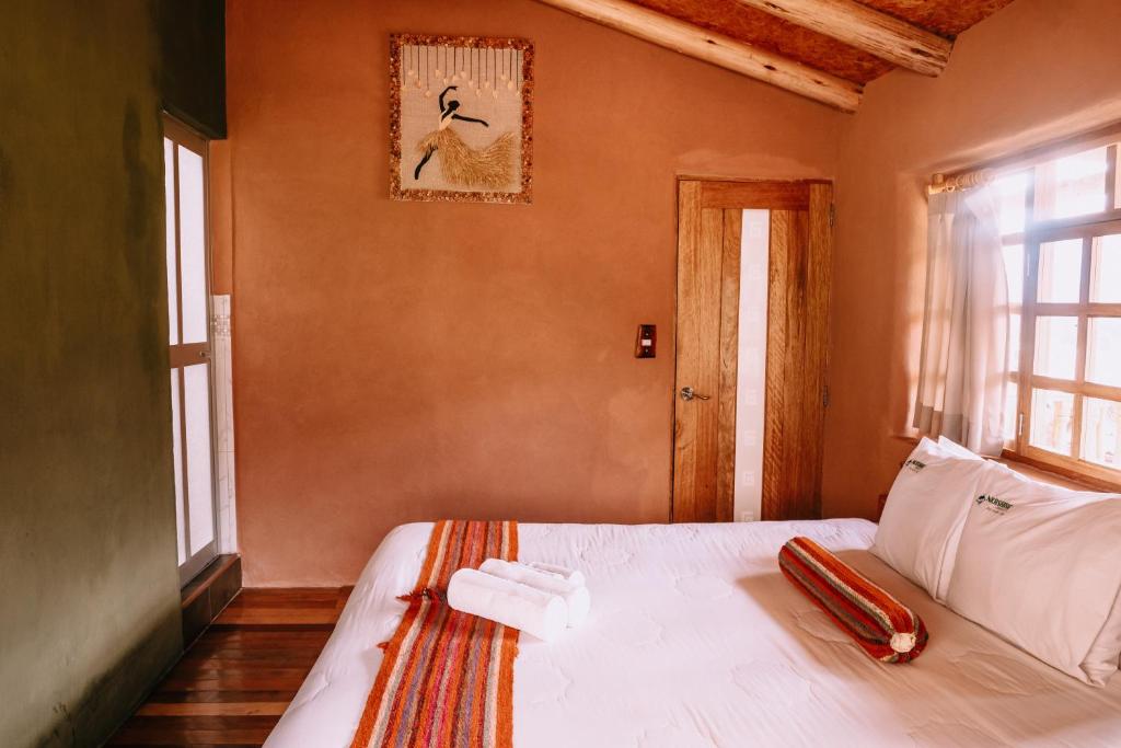 Postel nebo postele na pokoji v ubytování Inkasaire Boutique Lodge