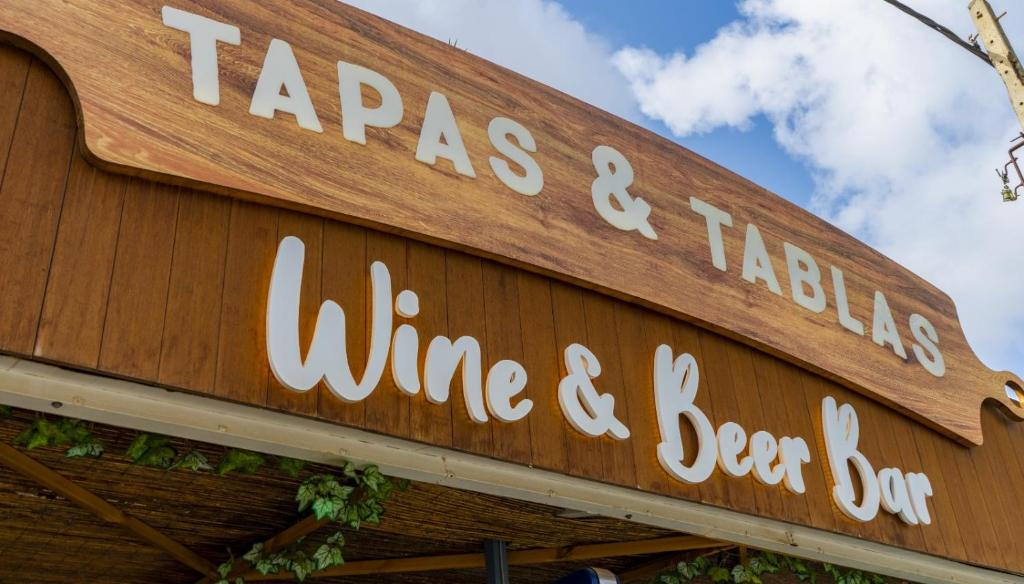 a sign for a wine and bar on a building at Tabbu ibiza apartments in Playa d'en Bossa