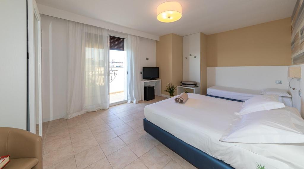 Postel nebo postele na pokoji v ubytování Hotel Nettuno