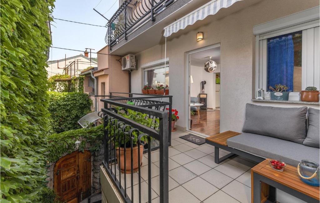 a balcony with a couch and plants on a building at 2 Bedroom Awesome Apartment In Selce in Selce