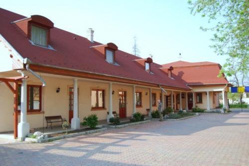 a large brick building with a red roof at Apartman116 Airport in Vecsés