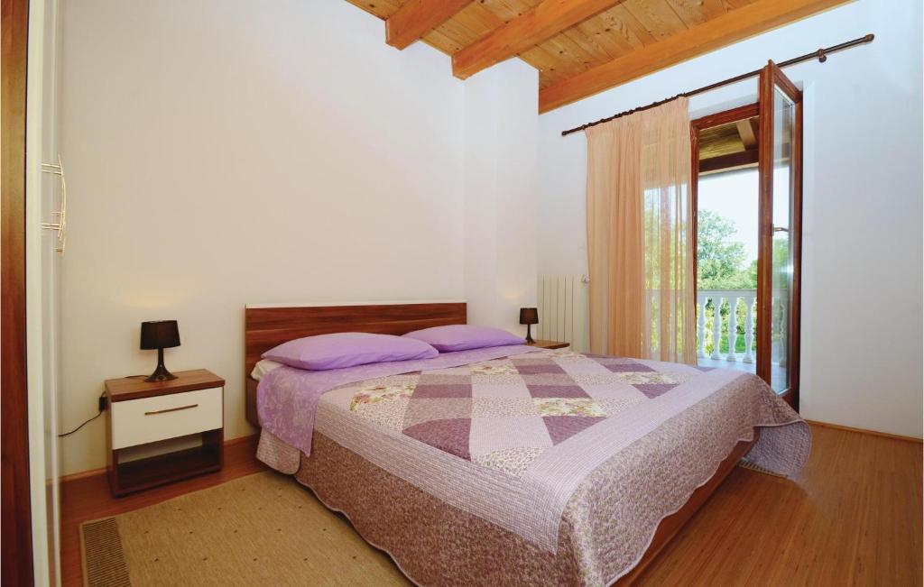 Postel nebo postele na pokoji v ubytování Holiday Home Jakacici Jakacici