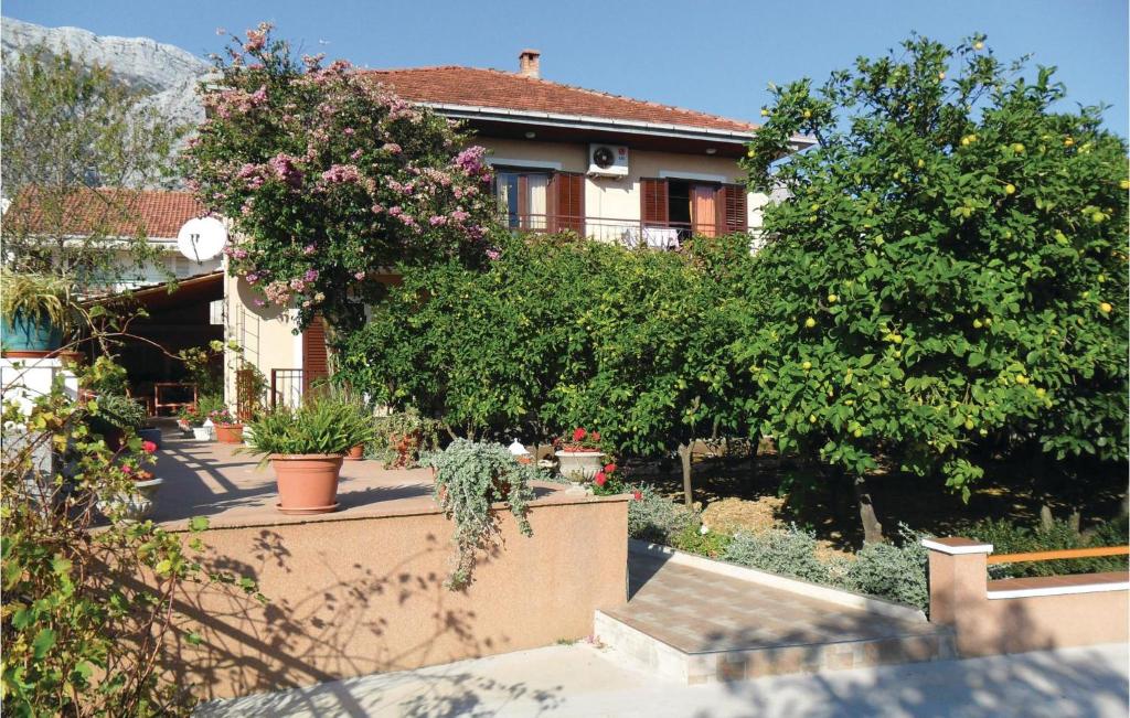 a house with trees and plants in front of it at Cozy Apartment In Orebic With Wifi in Orebić