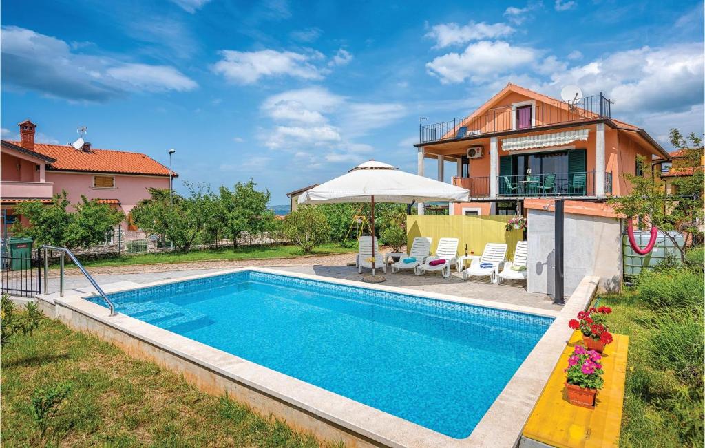 a swimming pool in front of a house at 1 Bedroom Stunning Apartment In Kastel in Kaštel