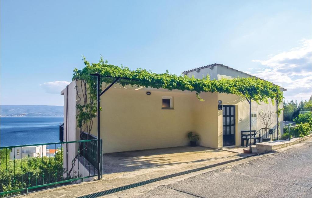 a house with vines growing on the side of it at Stunning Apartment In Suhi Potok With Kitchen in Sumpetar