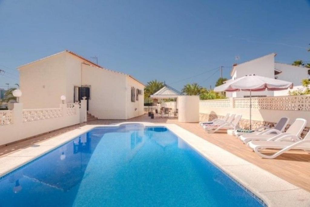 a villa with a swimming pool and a house at Casa Kollies in Calpe