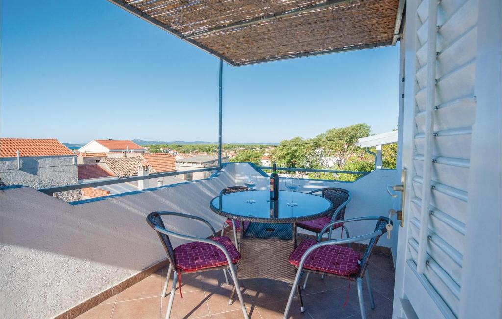 a patio with a table and chairs on a balcony at Cozy Apartment In Pakostane With Wifi in Pakoštane