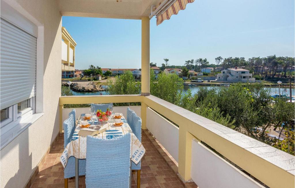 a balcony with a table and chairs and a view of the water at Gorgeous Apartment In Vir With House Sea View in Vir