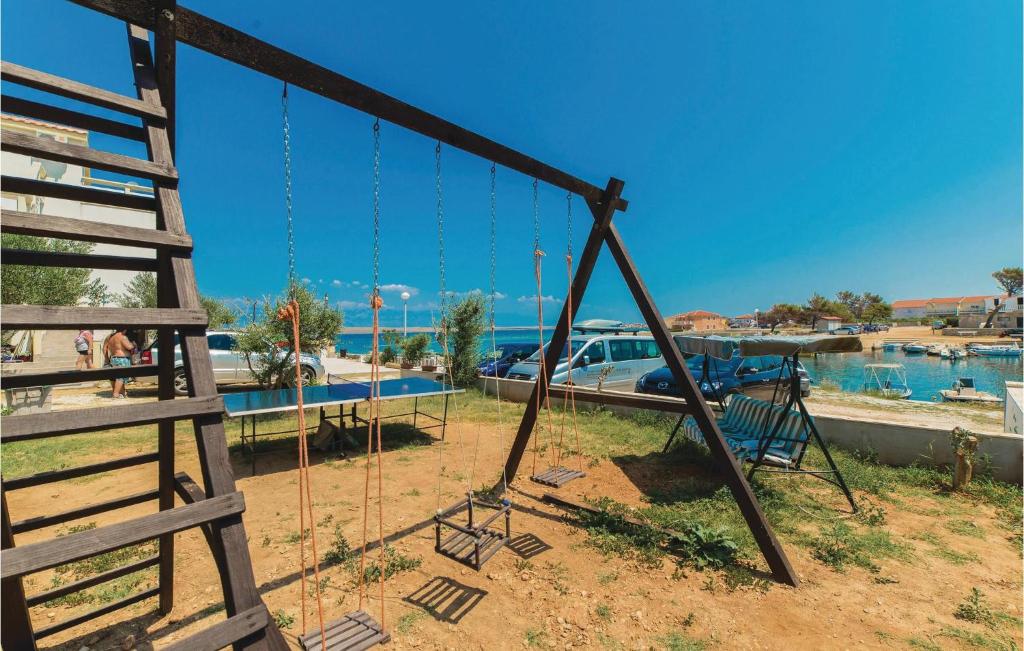 a swing set in a playground with a boat at Gorgeous Apartment In Vir With House Sea View in Vir
