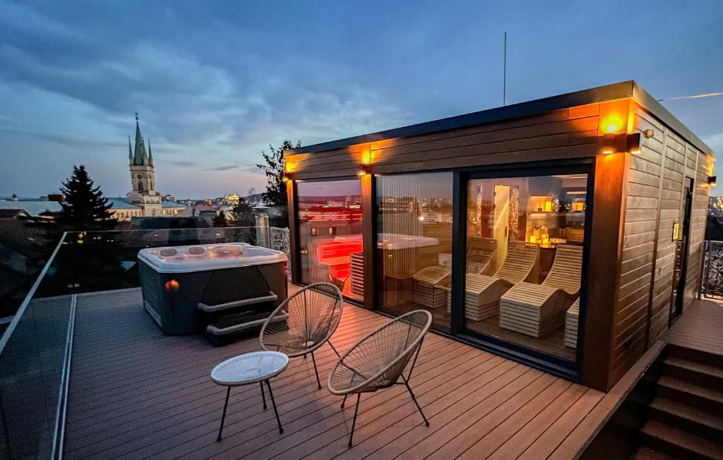 a small deck with two chairs and a table at BOUTIQUE HOTEL11 rooftop SPA in Nitra
