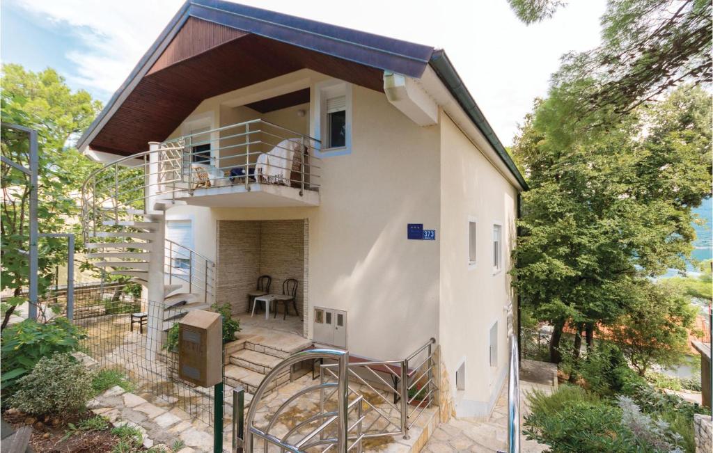 une maison avec un escalier menant à un balcon dans l'établissement Awesome Apartment In Donji Karin With Kitchen, à Donji Karin