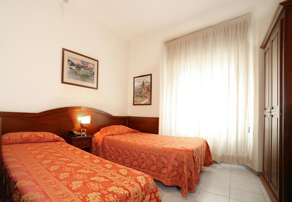 Postel nebo postele na pokoji v ubytování Hotel Pavone
