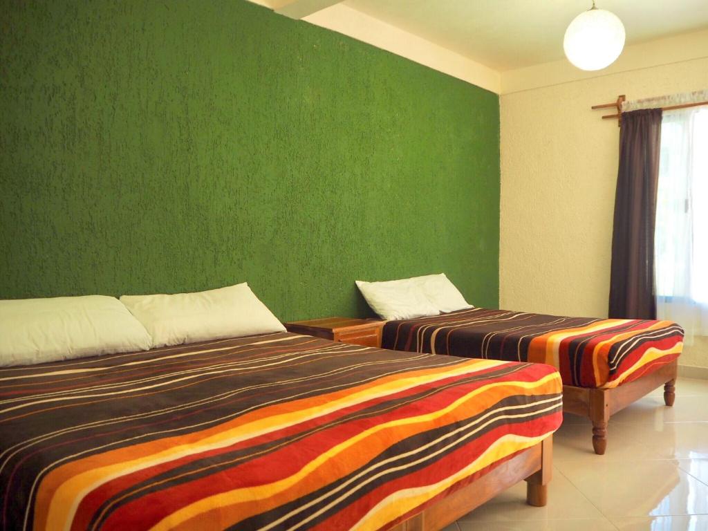 Postel nebo postele na pokoji v ubytování Hotel Maya Balam