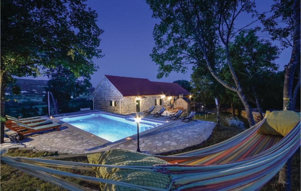a hammock in front of a swimming pool at Gorgeous Home In Hrvace With Wifi in Rumin