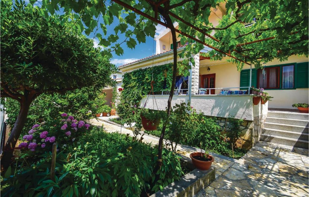 a garden with plants and flowers in front of a building at 3 Bedroom Lovely Apartment In Sibenik in Šibenik