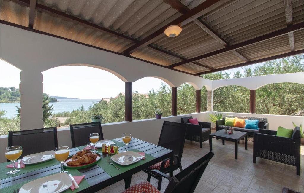 a patio with a table with food and drinks on it at Lovely Home In Vela Luka With Kitchen in Vela Luka