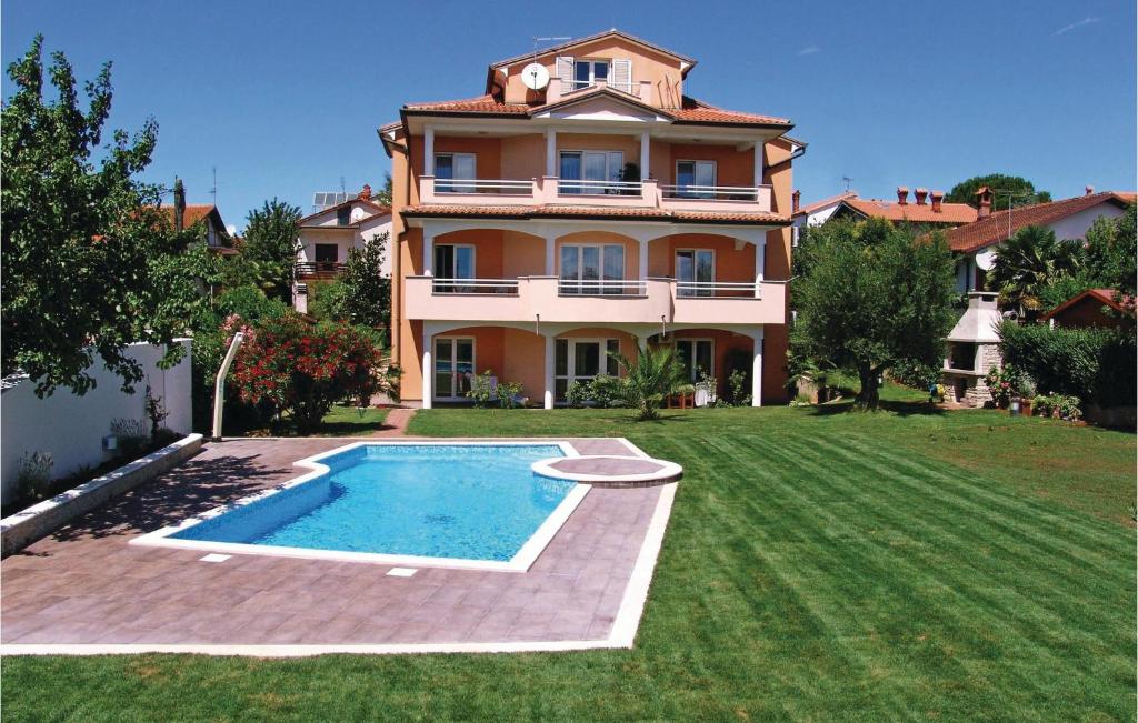 a large house with a swimming pool in the yard at Nice Apartment In Novigrad With Ethernet Internet in Novigrad Istria