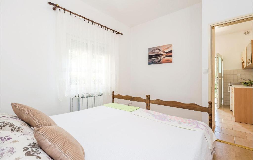 a bedroom with a white bed and a mirror at Awesome Apartment In Rijeka With Wifi in Rijeka