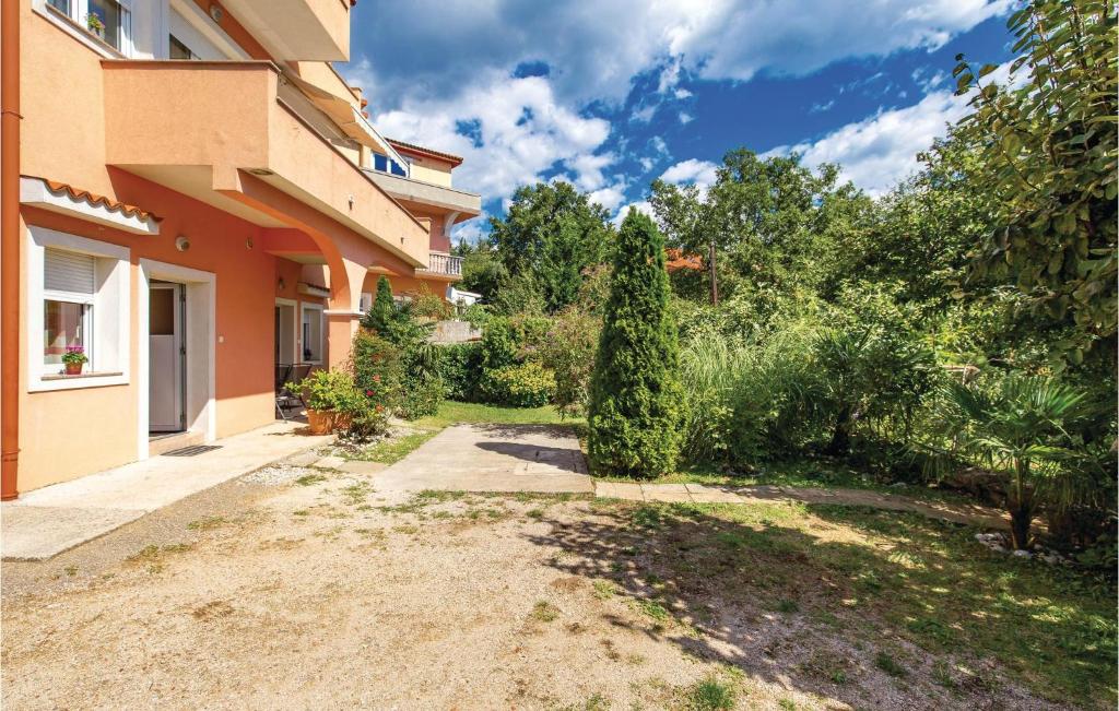 a house with a garden next to a building at Awesome Apartment In Rijeka With Wifi in Rijeka