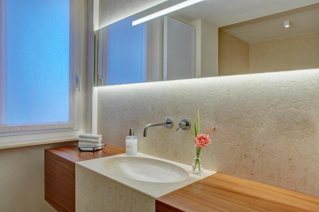 a bathroom with a sink and a mirror at Il Leccio - Luxury Resort Portofino Monte in Santa Margherita Ligure