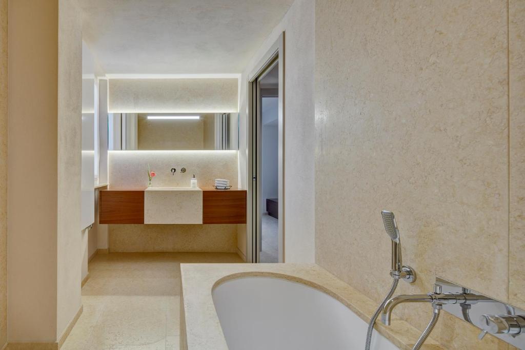 a bathroom with a sink and a mirror at Il Leccio - Luxury Resort Portofino Monte in Santa Margherita Ligure