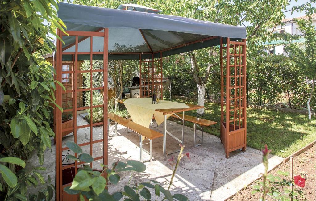 a pavilion with a table and chairs in a garden at Amazing Apartment In Rijeka With Wifi in Rijeka