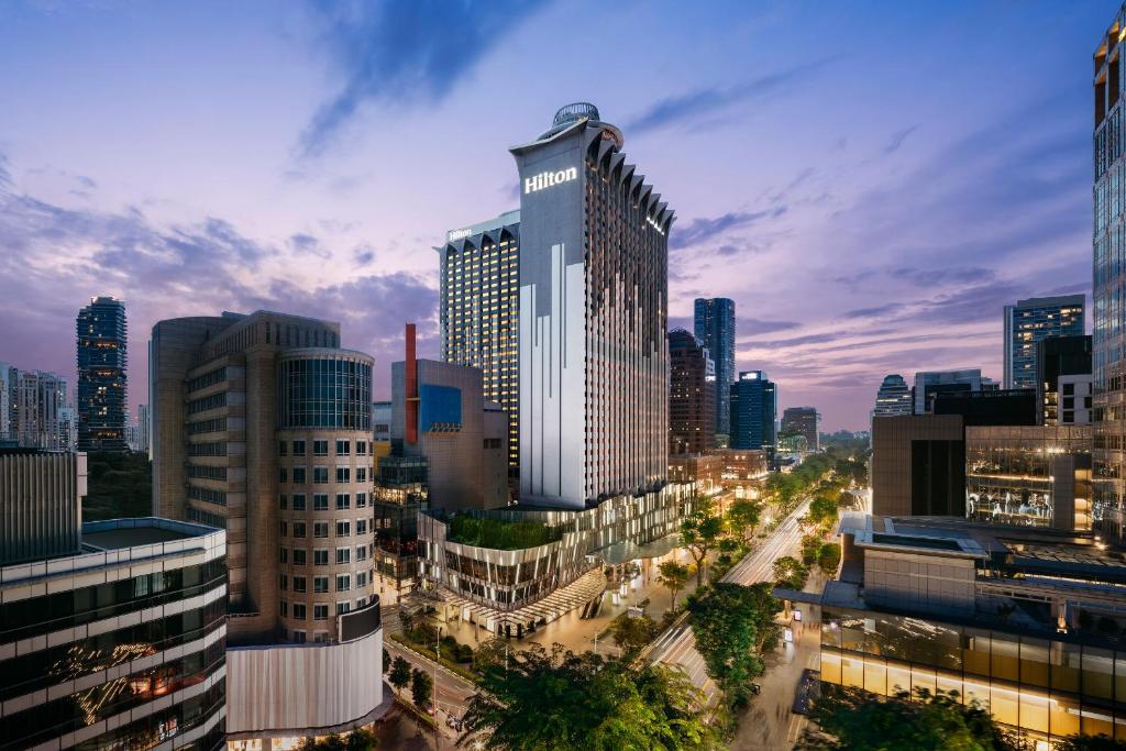 
a city with tall buildings and a clock tower at Hilton Singapore Orchard - SG Clean in Singapore
