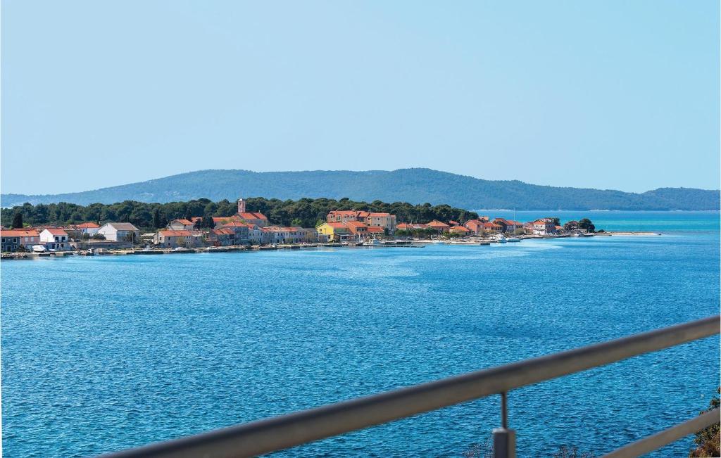 a view of a large body of water with houses at Two-Bedroom Apartment In Brodarica in Brodarica