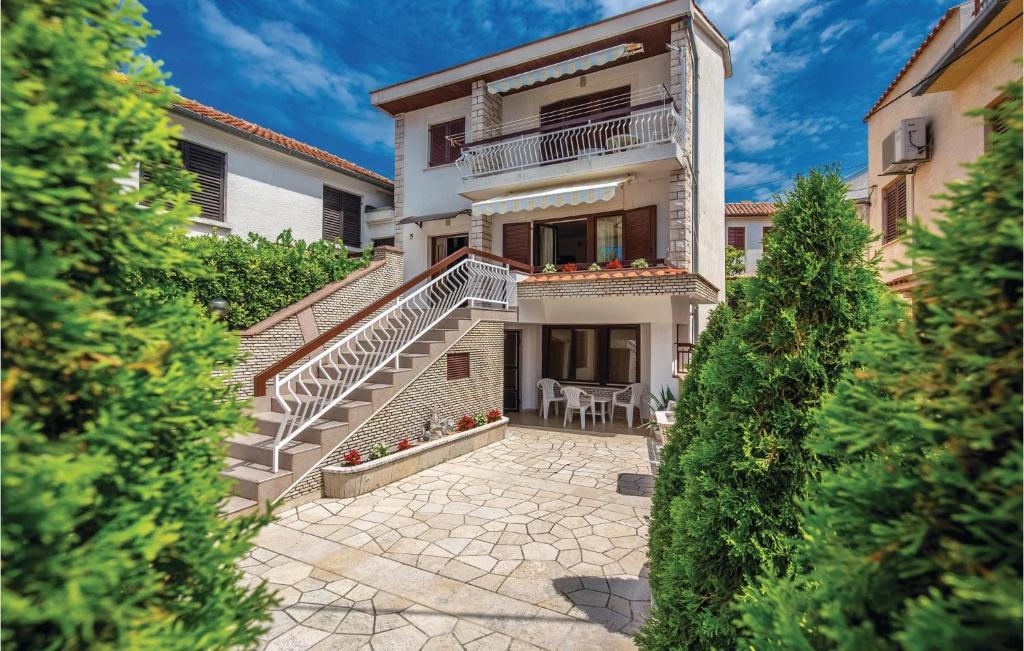 an exterior view of a house with stairs and a patio at Lovely Apartment In Jadranovo With Kitchen in Jadranovo